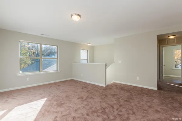 an empty room with windows and closet