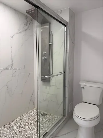 a bathroom with a shower and a toilet