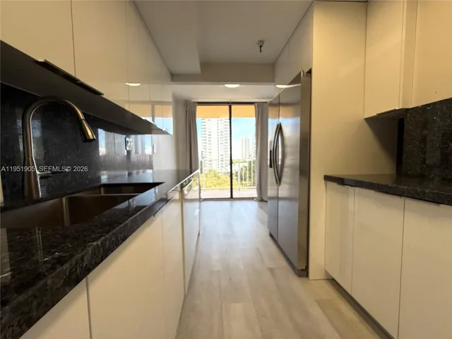 a stove top oven sitting inside of a kitchen