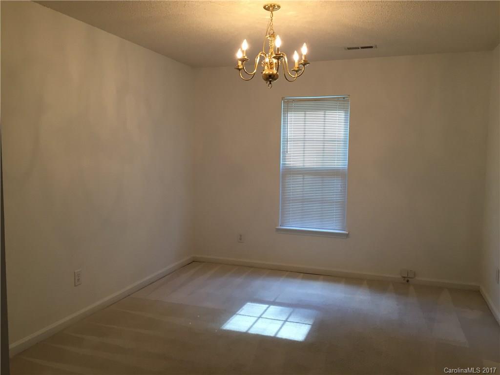 2224 Pimpernel Road Charlotte, NC 28213 - Photo 3 of 6 en empty room with windows and chandelier