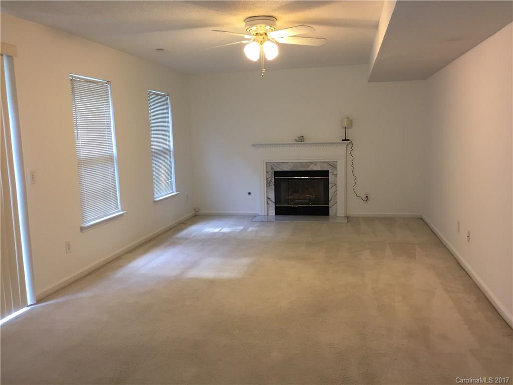 2224 Pimpernel Road Charlotte, NC 28213 - Photo 4 of 6 an empty room with windows and fireplace