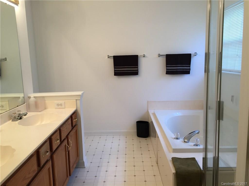 2224 Pimpernel Road Charlotte, NC 28213 - Photo 6 of 6 a bathroom with a sink a toilet a shower and mirror