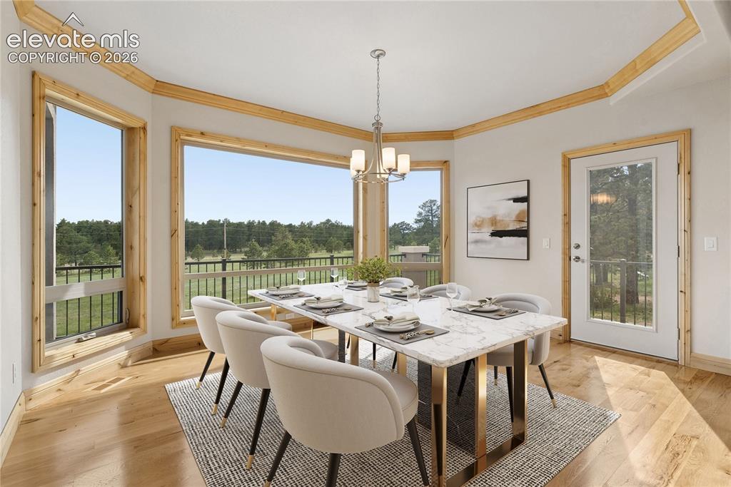 10840 Vollmer Road Colorado Springs, CO 80908 - Photo 23 of 49 a dining room with furniture window and wooden floor