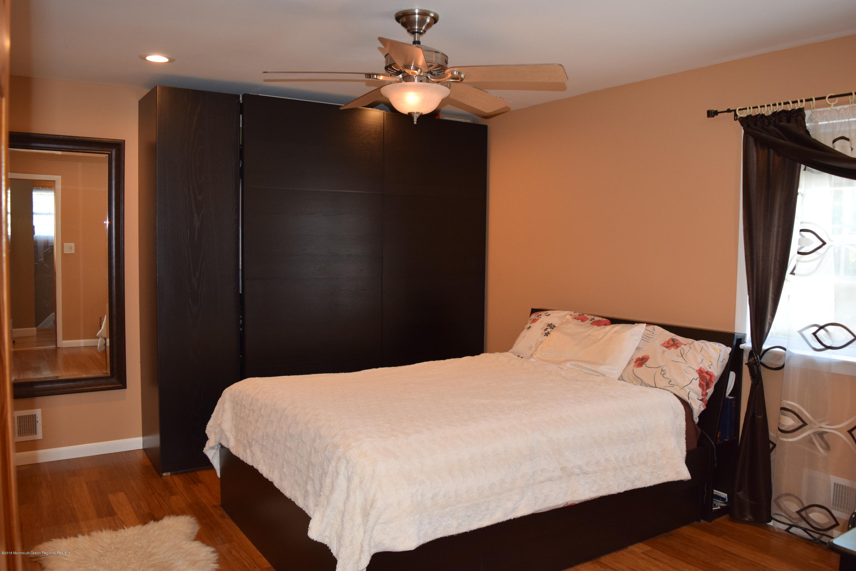 480 Adamston Road Brick, NJ 08723 - Photo 11 of 20 a bedroom with a bed and a chandelier
