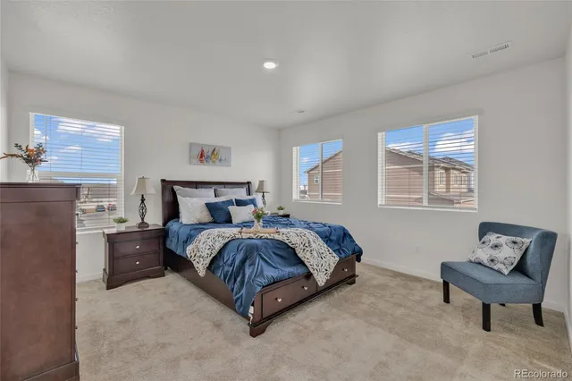 a spacious bedroom with a bed and window