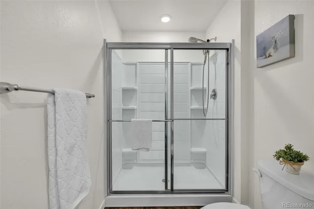 a bathroom with a glass shower door