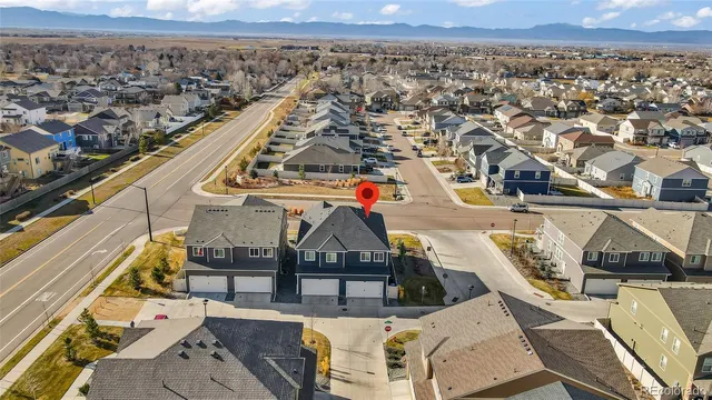 an aerial view of a balcony with two chairs