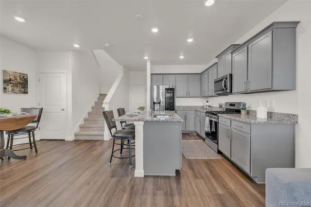 a kitchen with a sink stainless steel appliances and cabinets