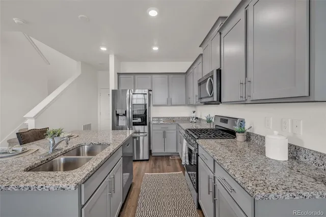 a kitchen with a sink stove and refrigerator