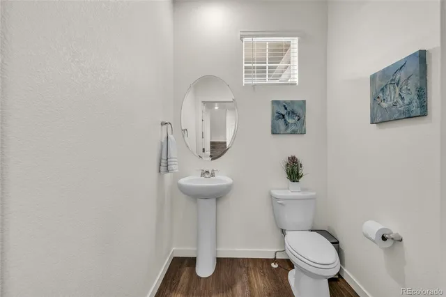 a white toilet sitting next to a bathroom sink