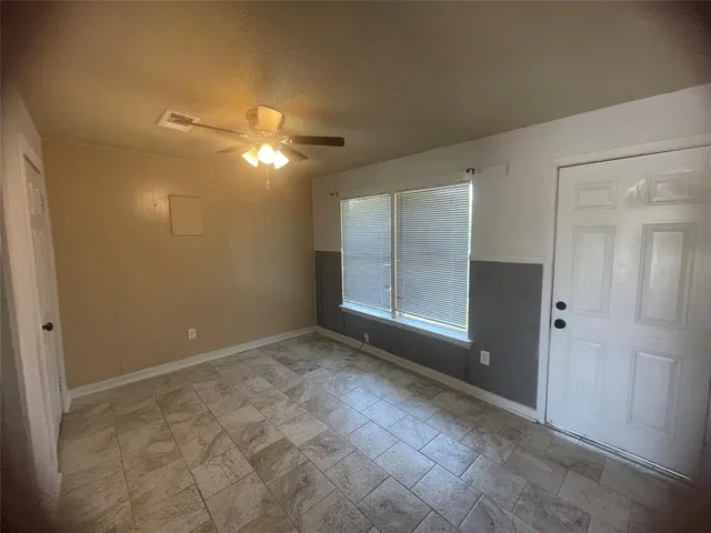 a kitchen with refrigerator and cabinets