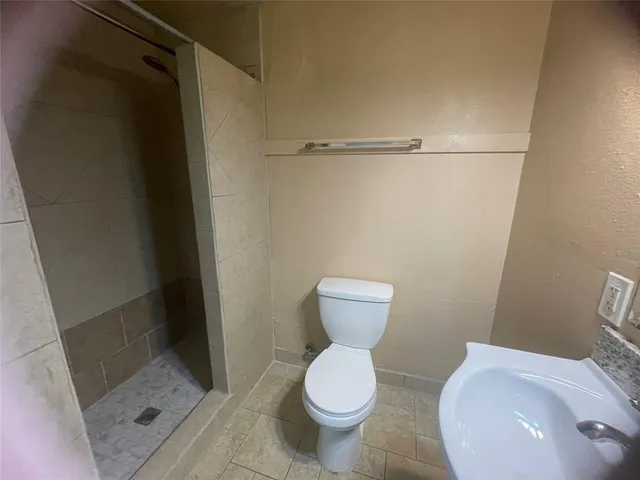 a bathroom with a sink toilet and a mirror