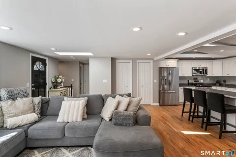 a living room with furniture and kitchen view