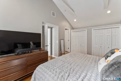 a bedroom with a bed and a television