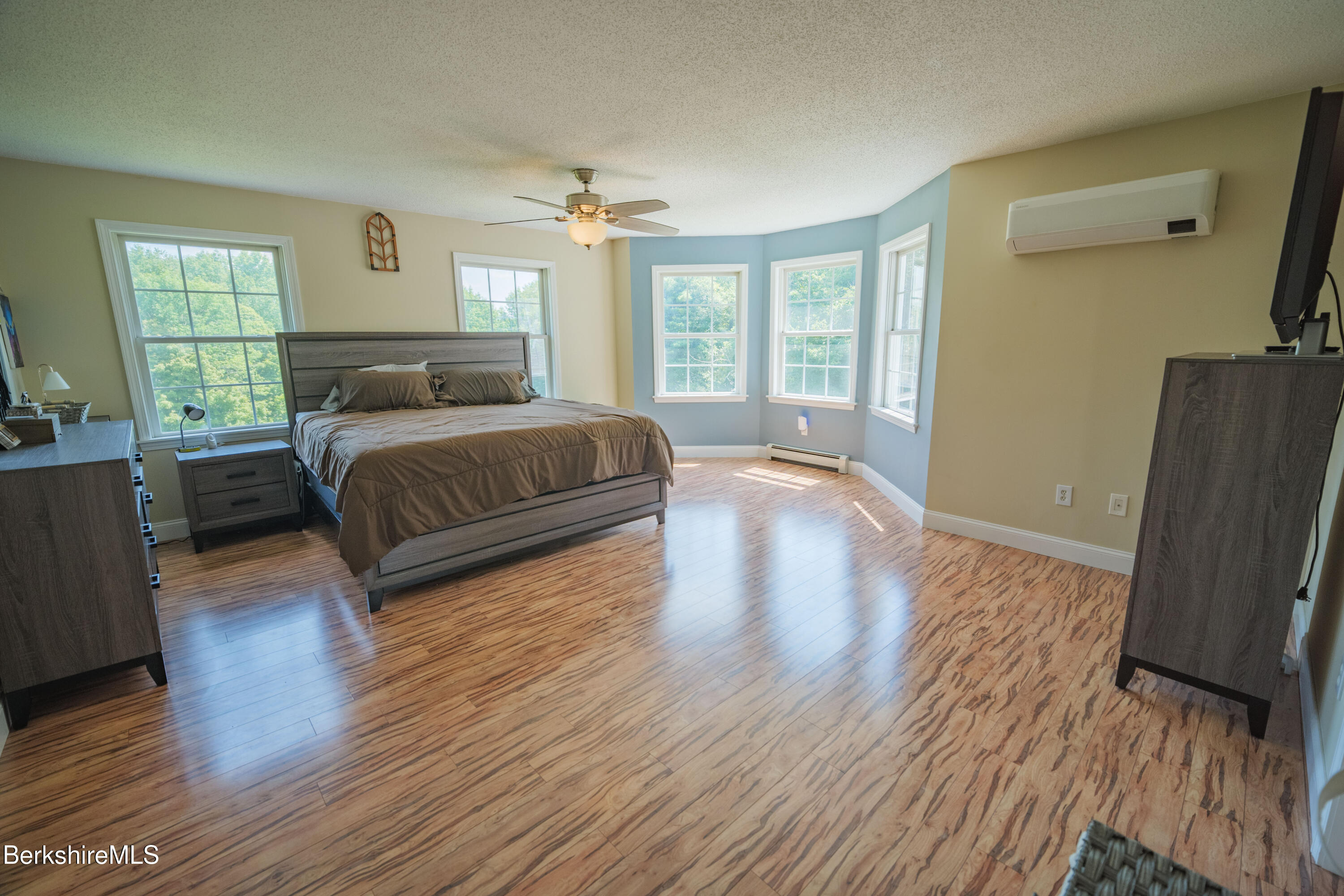 155 High St Hill Road Windsor, MA 01270 - Photo 13 of 26 a spacious bedroom with a large bed a flat tv screen and a dresser