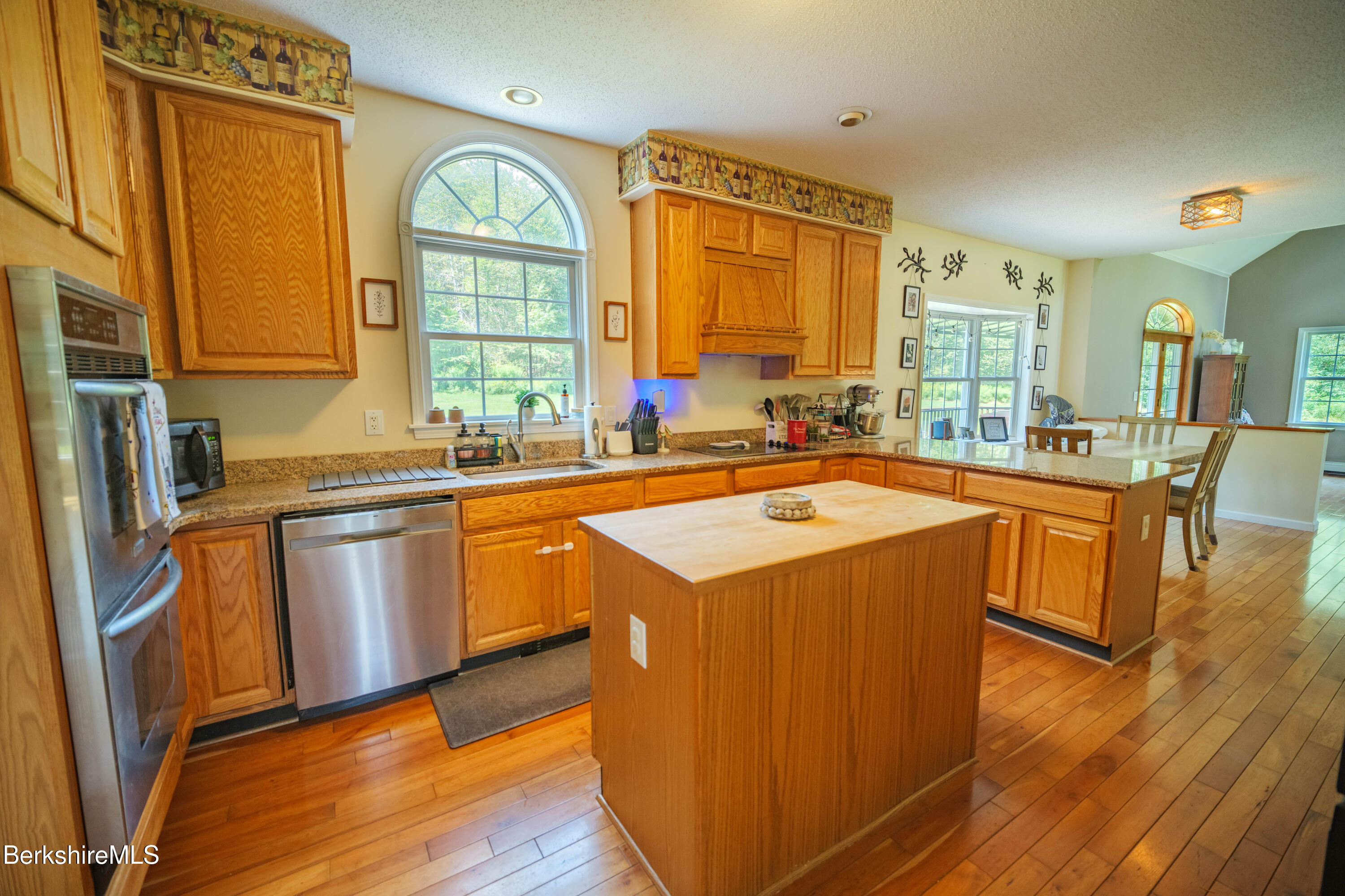 155 High St Hill Road Windsor, MA 01270 - Photo 3 of 26 a kitchen with stainless steel appliances granite countertop a sink stove and wooden floor