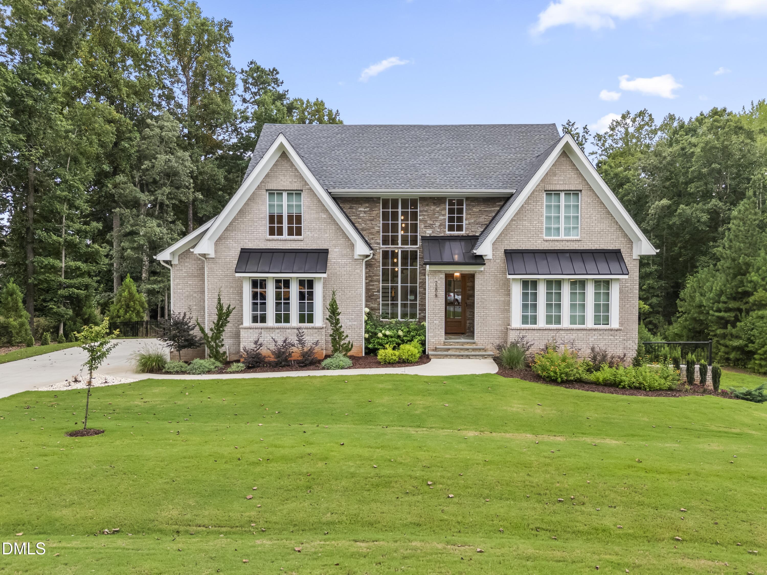 a front view of a house with a garden
