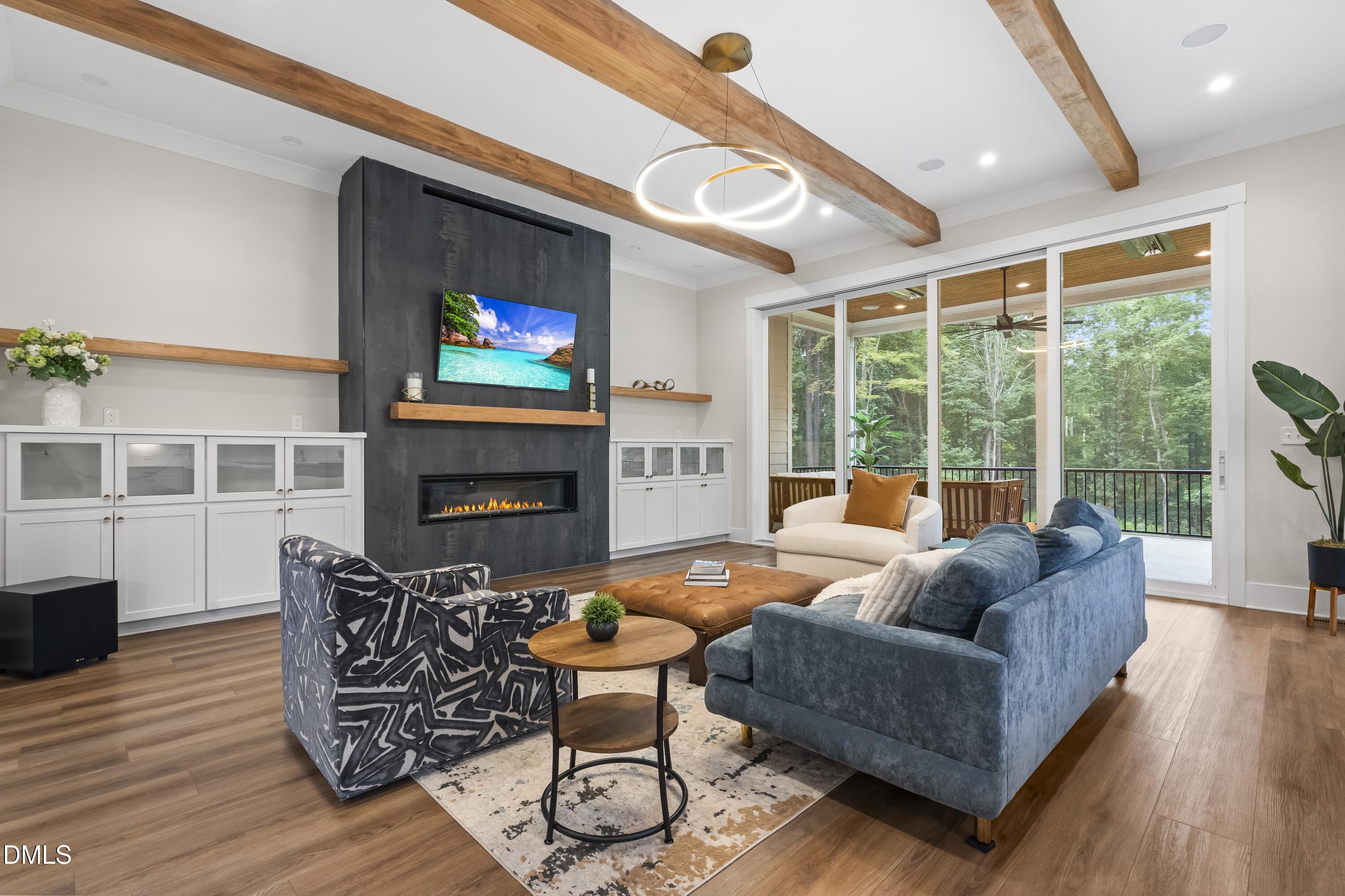 2205 Duskywing Drive Raleigh, NC 27613 - Photo 11 of 38 a living room with furniture a fireplace and a large window