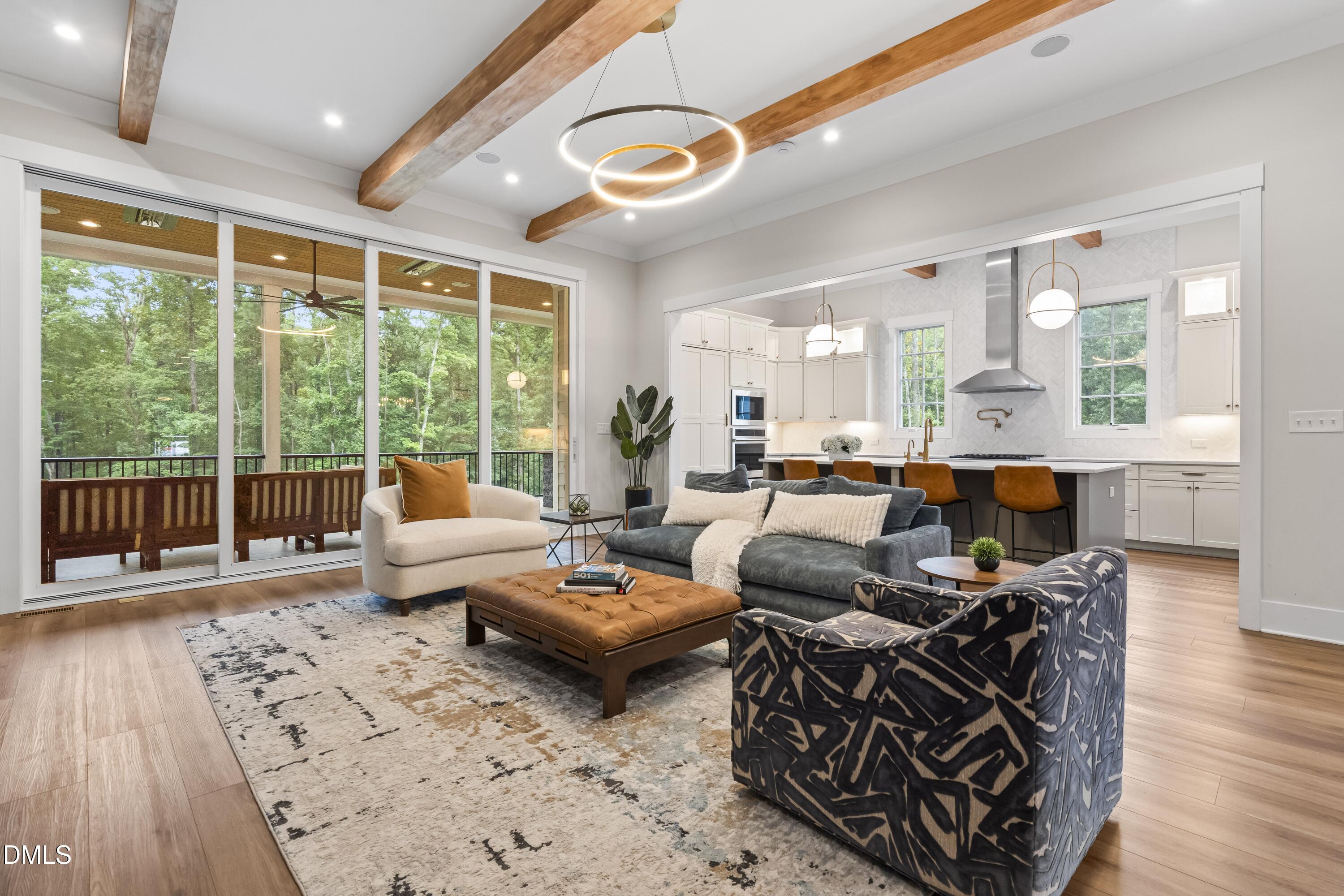 2205 Duskywing Drive Raleigh, NC 27613 - Photo 13 of 38 a living room with furniture large windows and wooden floor