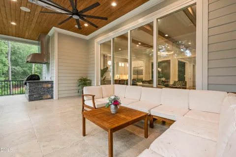 a kitchen with stainless steel appliances kitchen island granite countertop a table chairs and a refrigerator