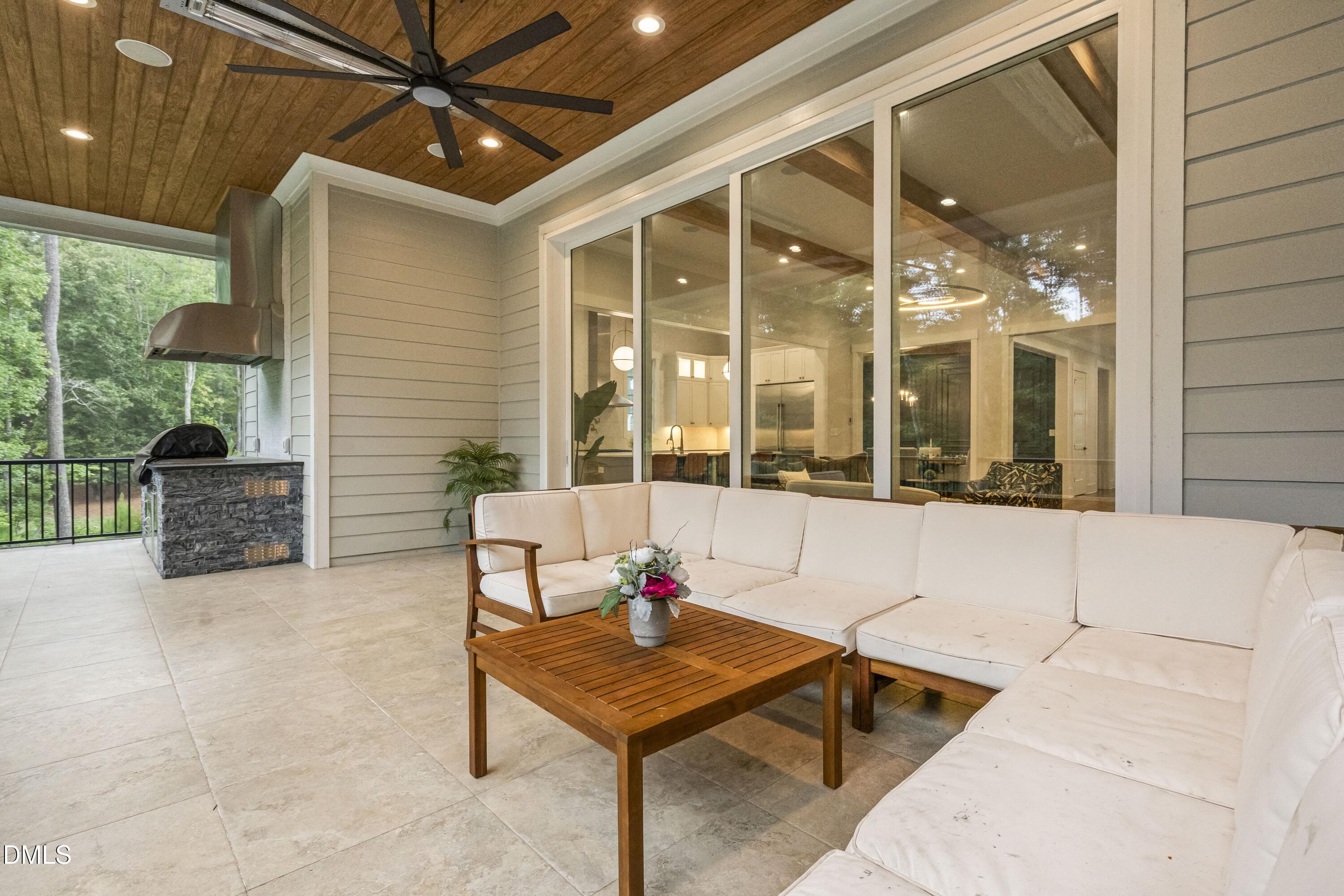 2205 Duskywing Drive Raleigh, NC 27613 - Photo 16 of 38 a living room with patio furniture and a floor to ceiling window