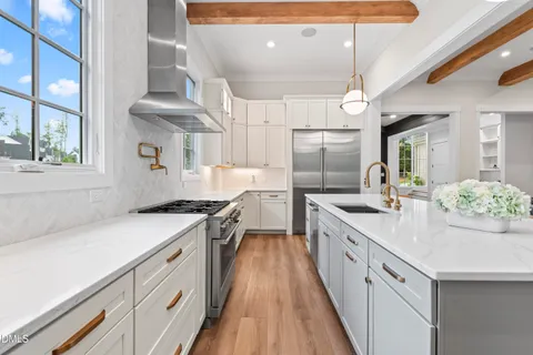 a stove top oven sitting inside of a kitchen