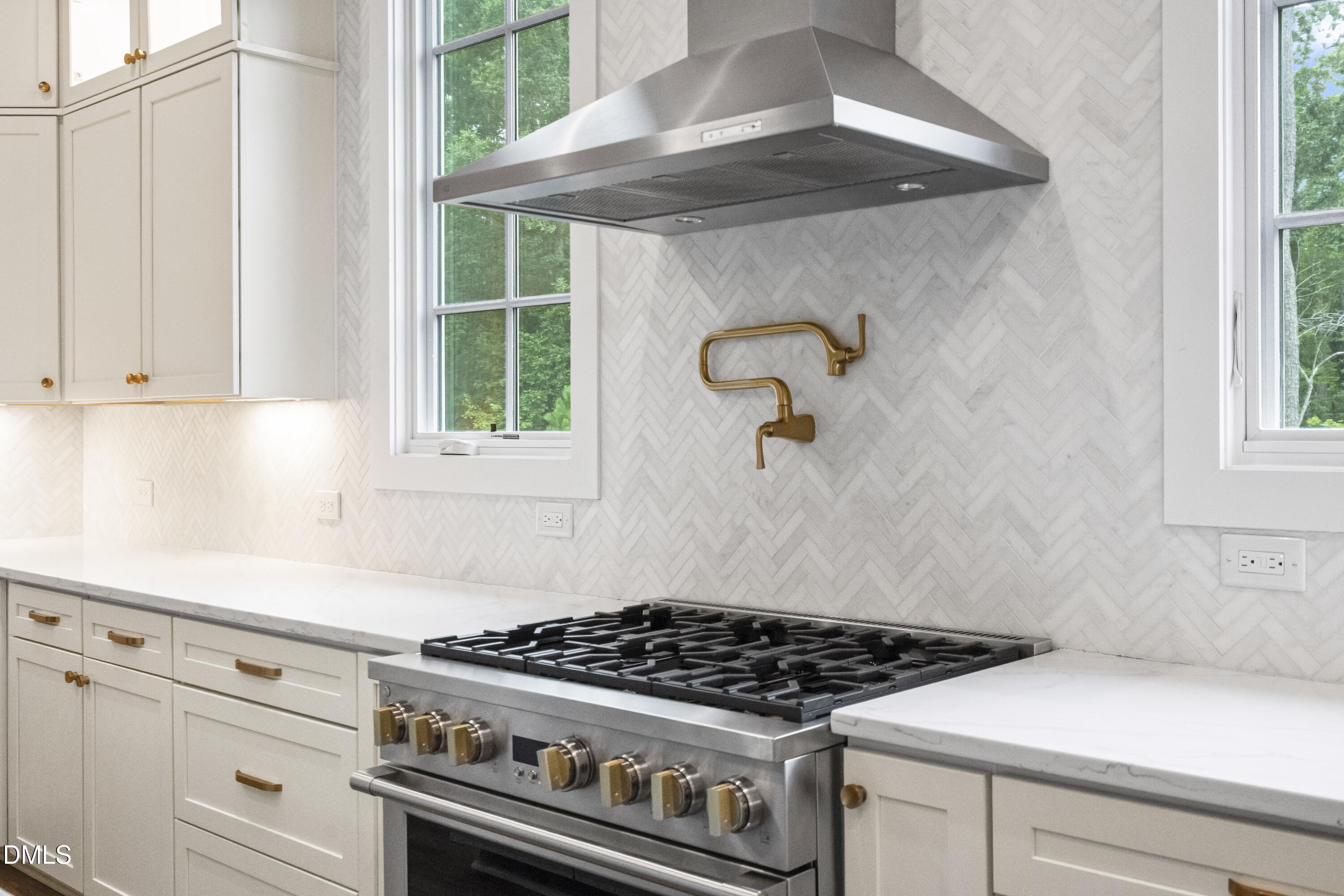 2205 Duskywing Drive Raleigh, NC 27613 - Photo 19 of 38 a stove top oven sitting inside of a kitchen