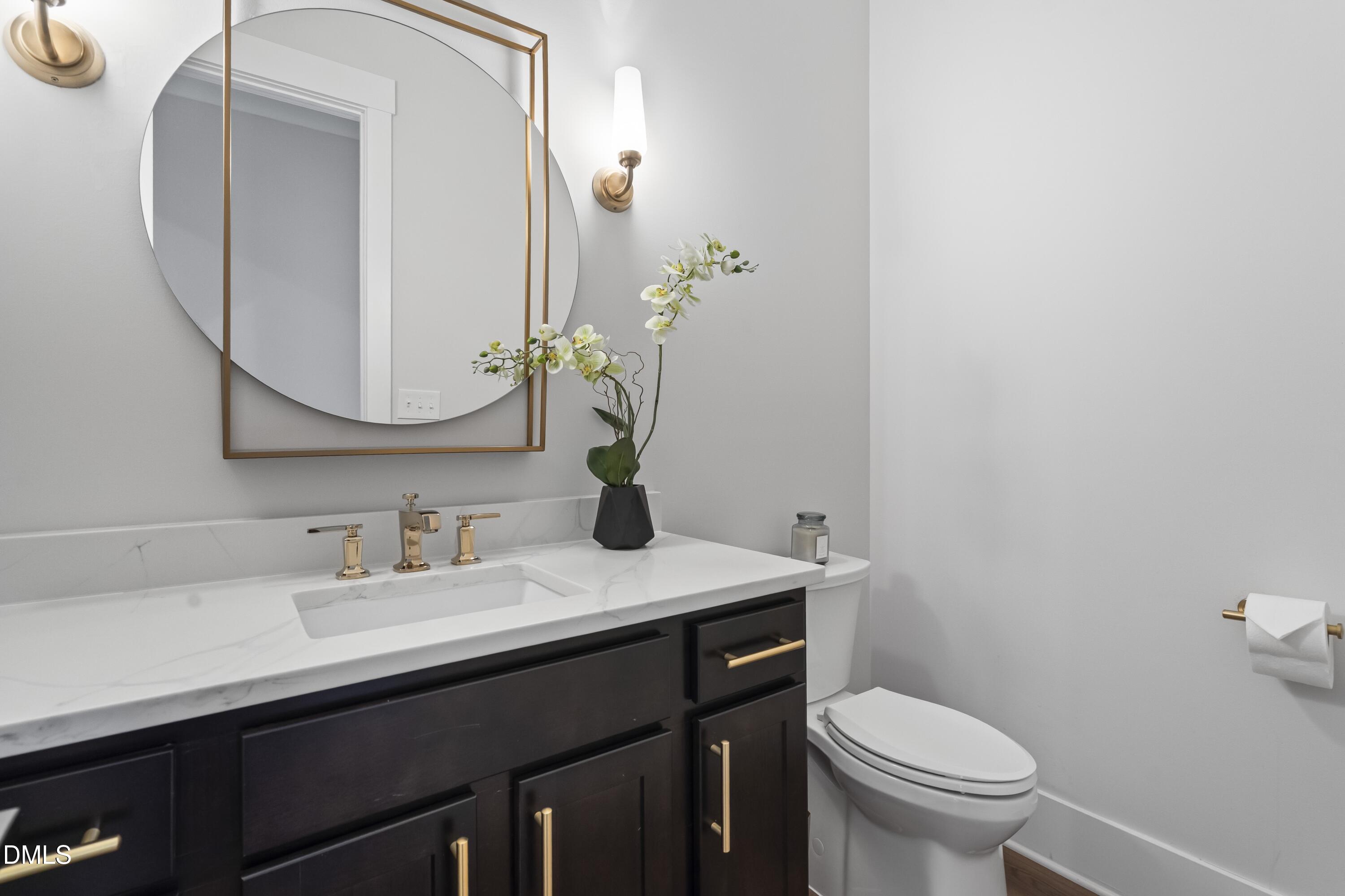 2205 Duskywing Drive Raleigh, NC 27613 - Photo 20 of 38 a bathroom with a granite countertop sink mirror and toilet
