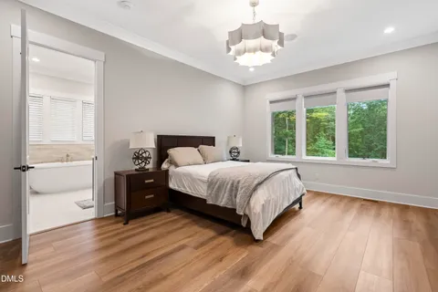a bathroom with a white tub sitting next to a window