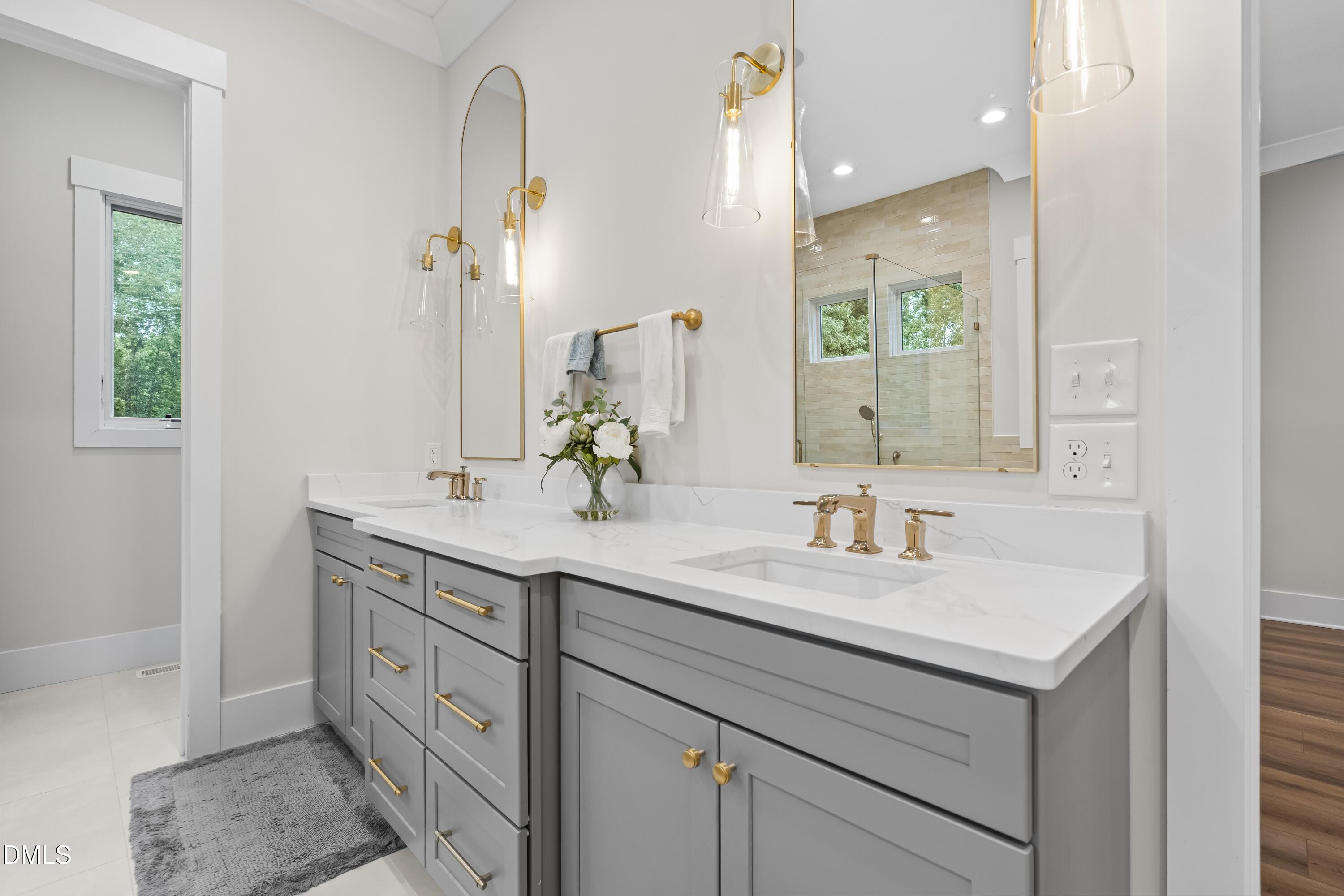 2205 Duskywing Drive Raleigh, NC 27613 - Photo 24 of 38 a bathroom with a sink and a mirror