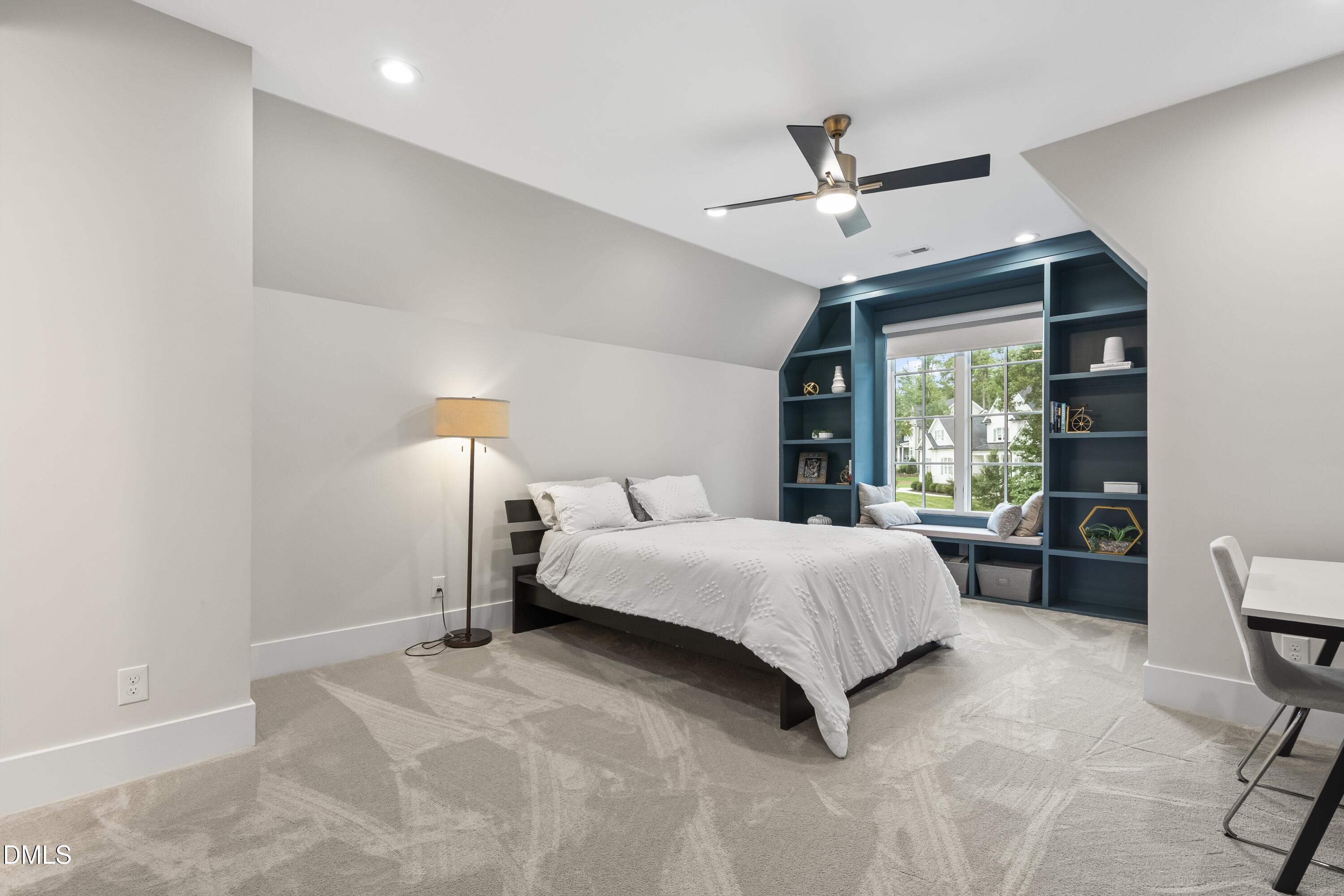 2205 Duskywing Drive Raleigh, NC 27613 - Photo 29 of 38 a spacious bedroom with a bed a dresser and a large window