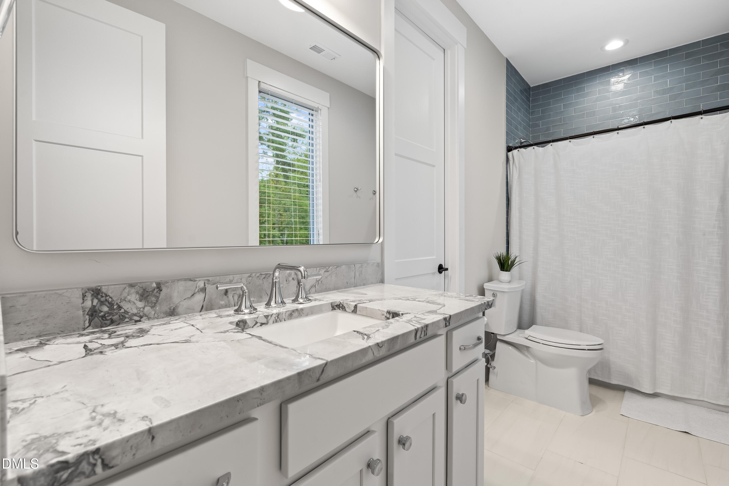 2205 Duskywing Drive Raleigh, NC 27613 - Photo 30 of 38 a bathroom with a sink and a toilet