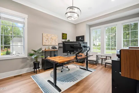 a living room with lots of furniture and book shelf