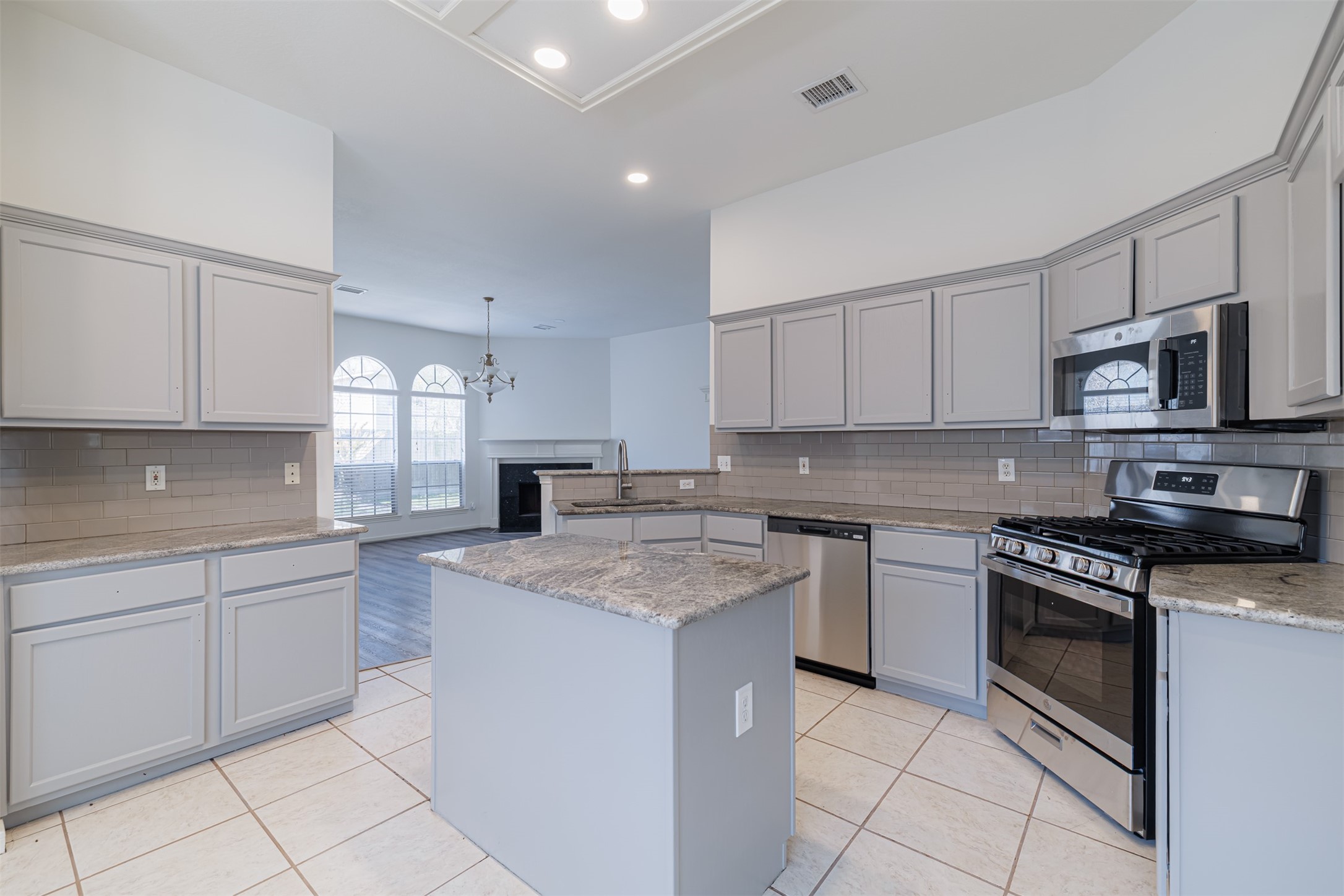 15022 Sapling Oak Court Houston, TX 77082 - Photo 11 of 32 a kitchen with granite countertop cabinets stainless steel appliances and a counter space