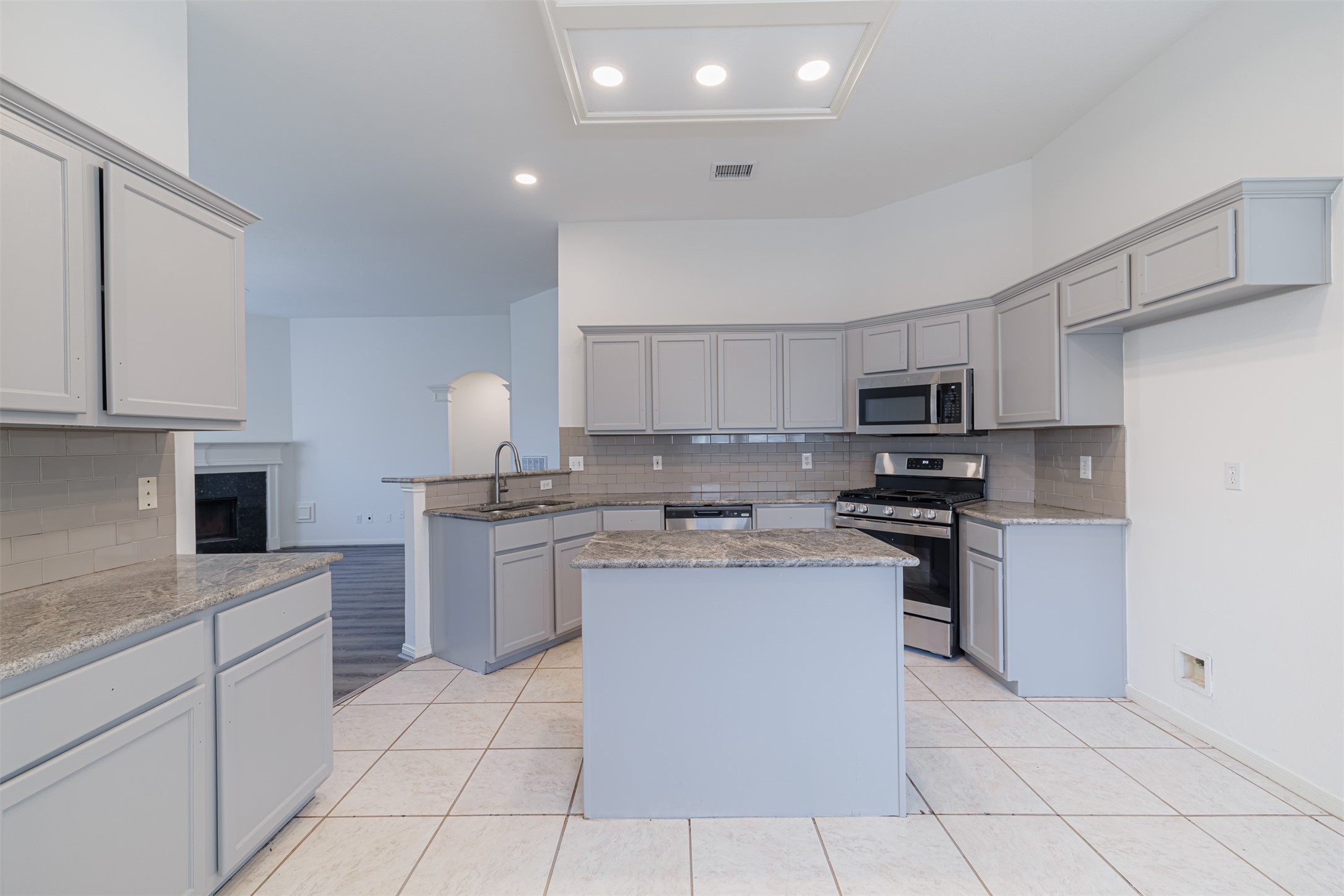 15022 Sapling Oak Court Houston, TX 77082 - Photo 12 of 32 a kitchen with stainless steel appliances granite countertop a sink and stove top oven