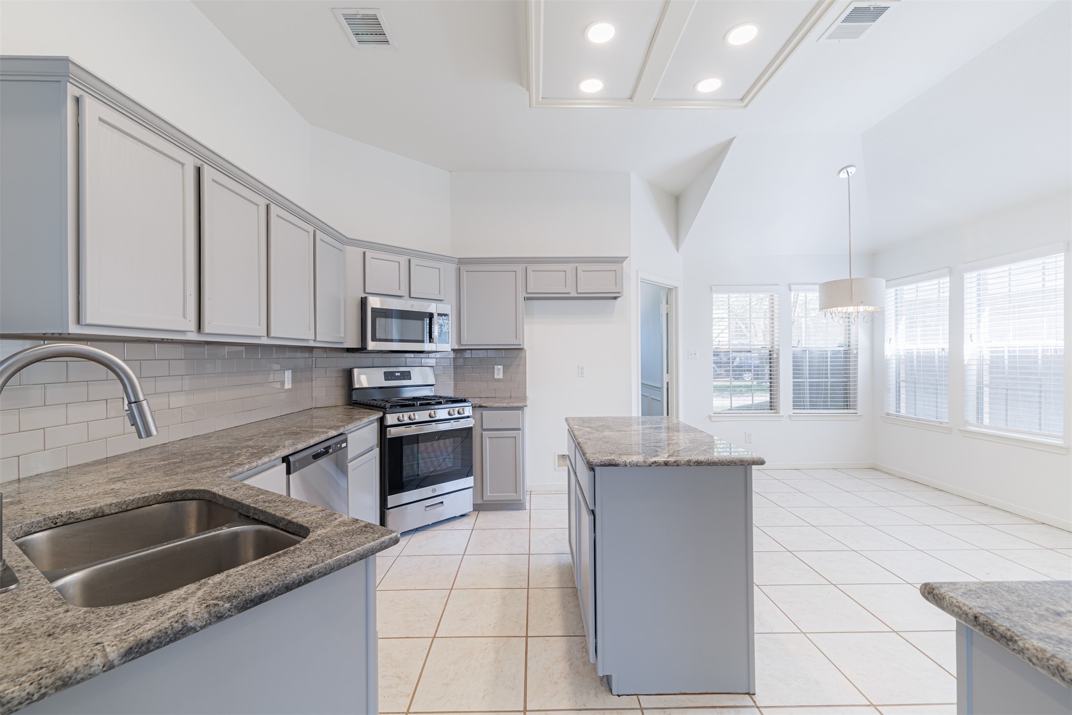 15022 Sapling Oak Court Houston, TX 77082 - Photo 13 of 32 a kitchen with stainless steel appliances granite countertop a sink stove and cabinets