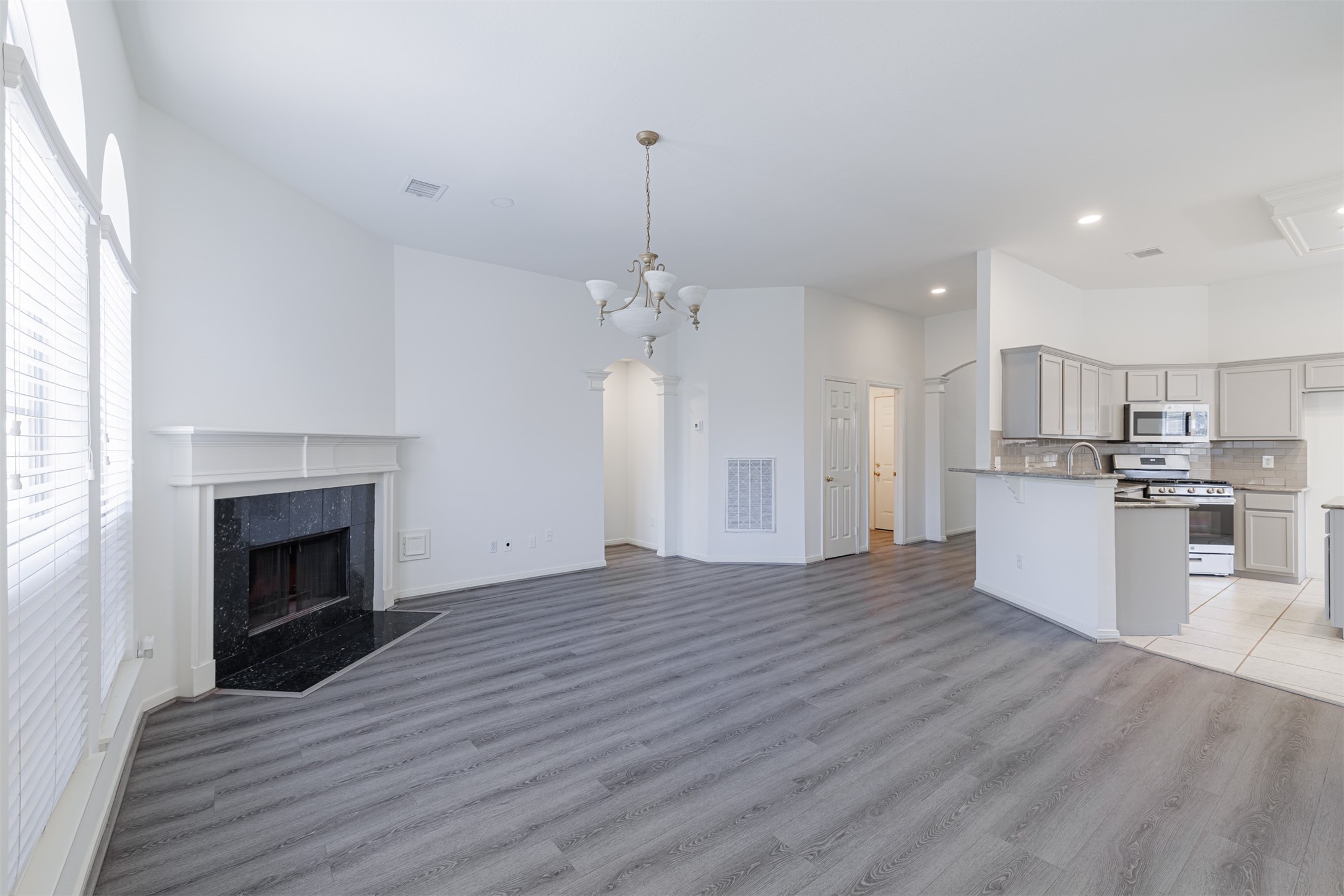 15022 Sapling Oak Court Houston, TX 77082 - Photo 17 of 32 a view of a kitchen with a sink and a fireplace