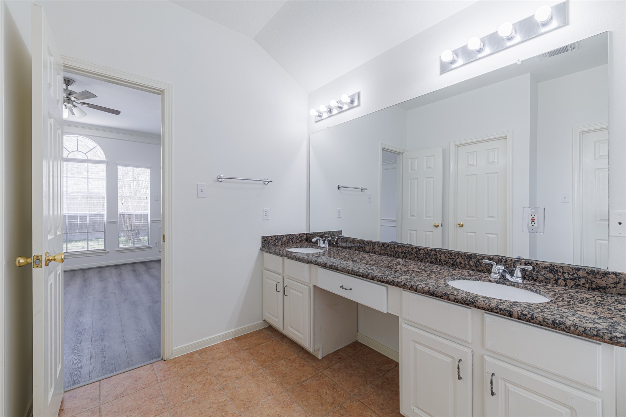 15022 Sapling Oak Court Houston, TX 77082 - Photo 23 of 32 a bathroom with a granite countertop sink and a mirror