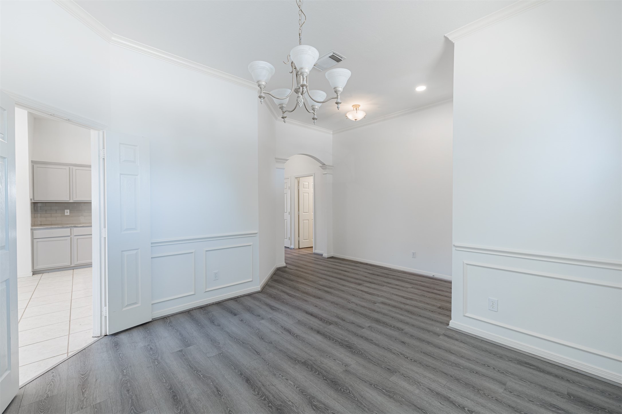 15022 Sapling Oak Court Houston, TX 77082 - Photo 7 of 32 a view of a room with wooden floor and chandelier