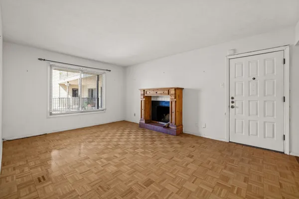 a view of empty room with a fireplace