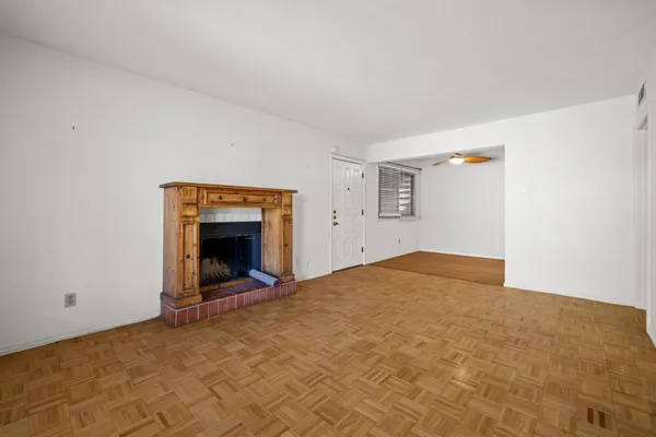a view of an empty room and fire place