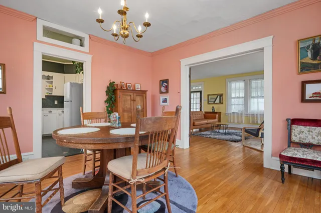 a view of a dining room with furniture wooden floor and a chandelier