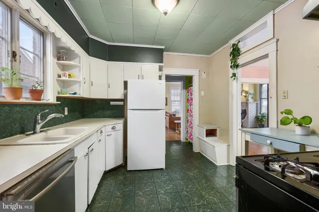 a kitchen with a refrigerator and a stove