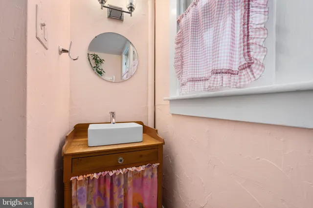a bathroom with a mirror and a sink