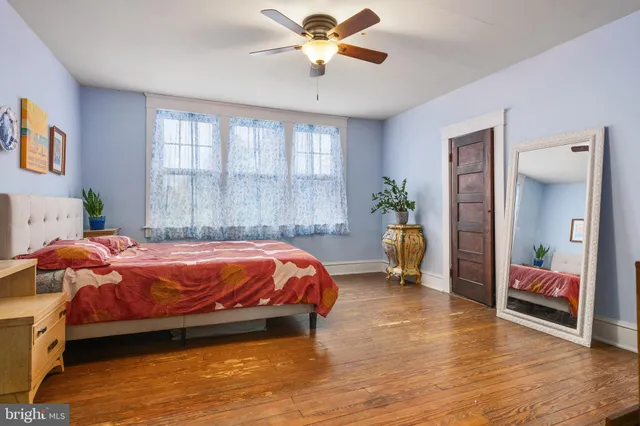 a spacious bedroom with a bed and window
