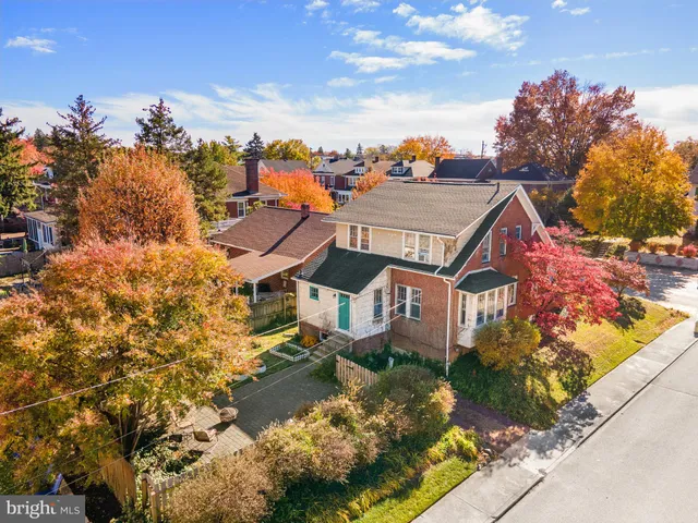 aerial view of a house with a yard and balcony