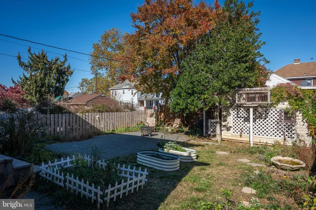a view of a backyard with table and chairs and a fire pit