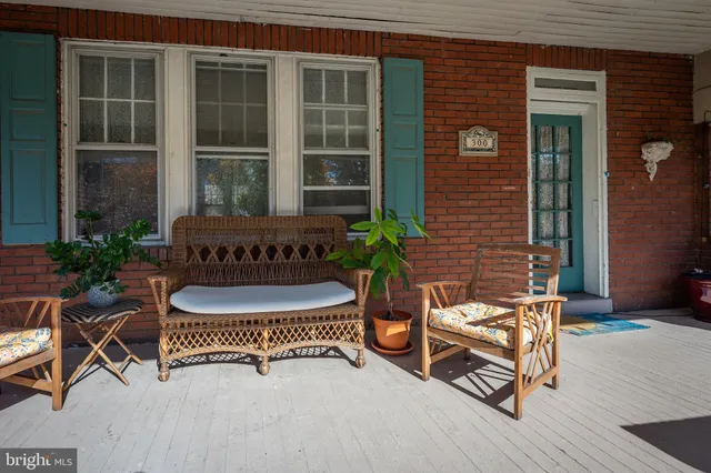 a balcony with table and chairs