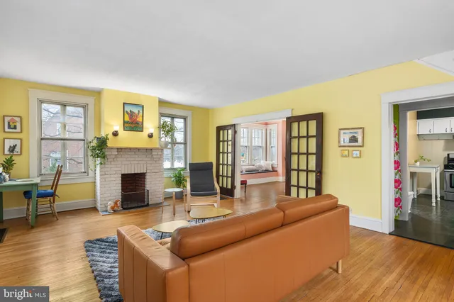 a living room with fireplace furniture and a wooden floor