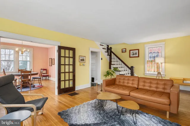 a living room with furniture wooden floor and a table